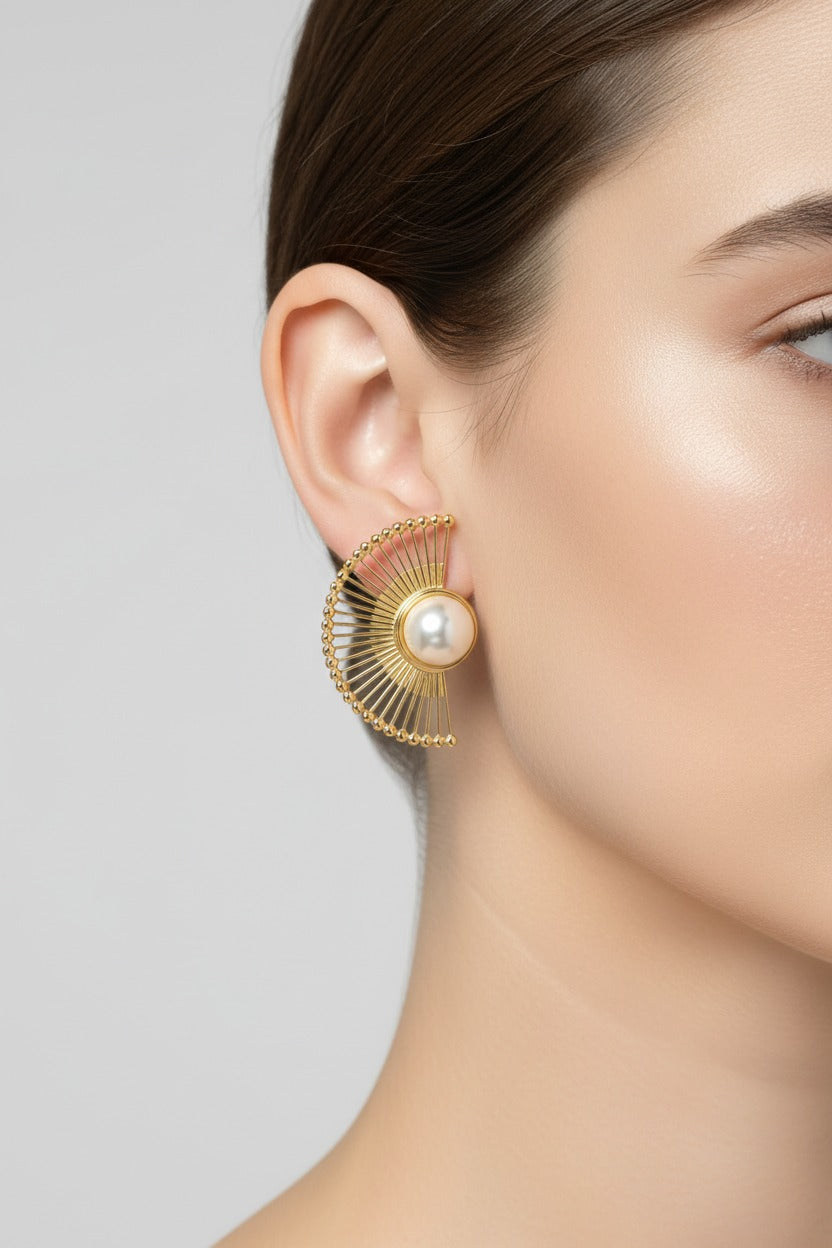 Radiant fan pearl earrings worn on ear in 18K PVD gold plated stainless steel