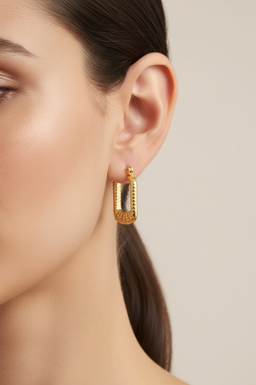 Rectangular textured hoop earrings crafted from stainless steel with 18K PVD gold plating, featuring a bold geometric frame and raised textured detailing