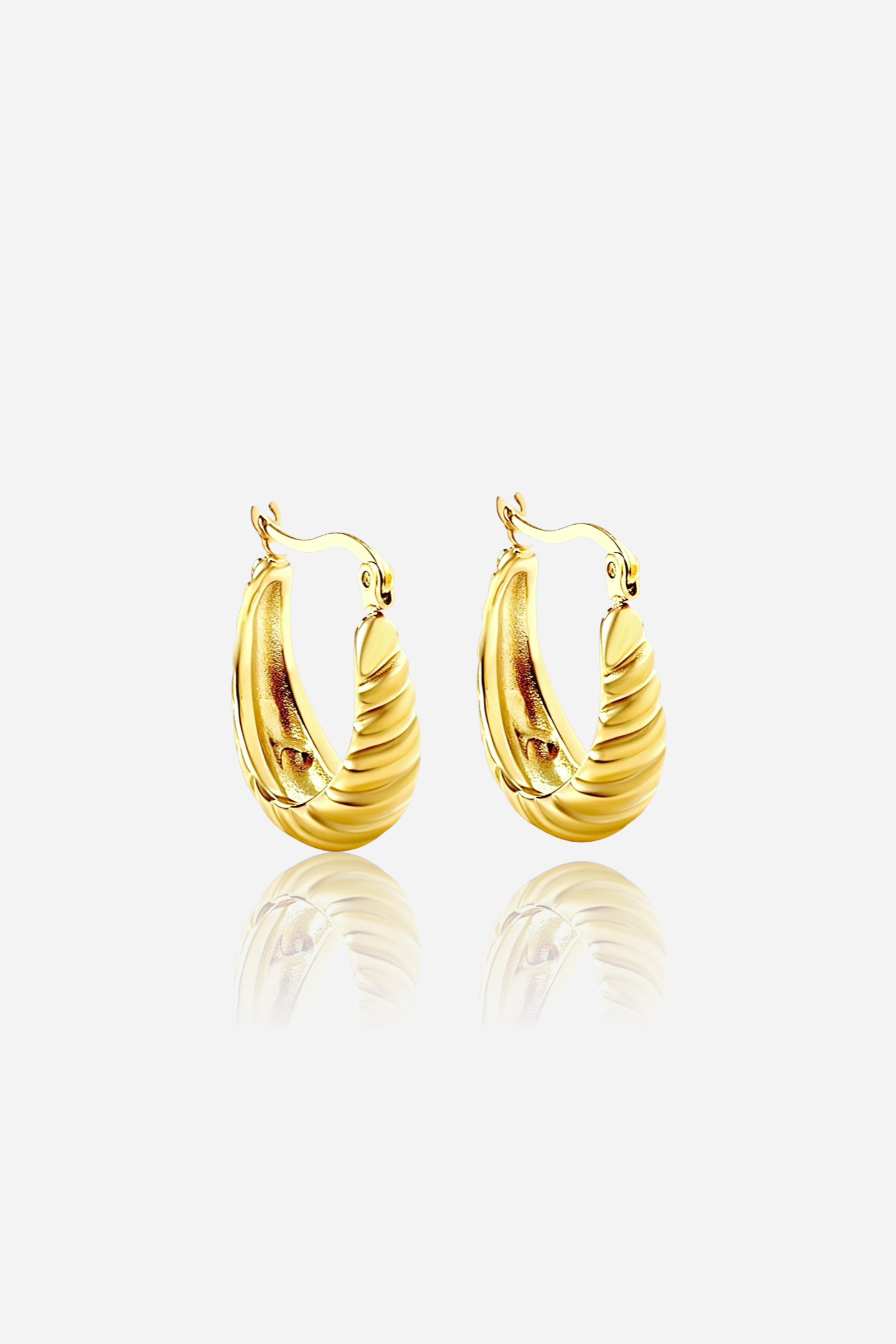 Ribbed gold hoop earrings in 18K PVD gold plated stainless steel, featuring a sculptural ribbed texture and bold curved silhouette — GLISTIA elegant statement earrings