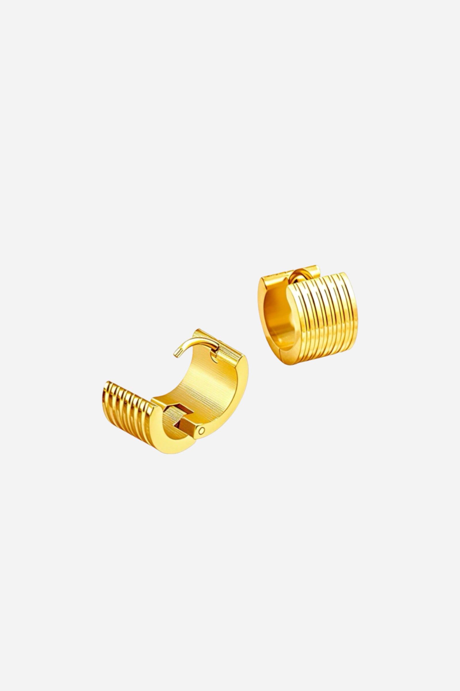 Close-up of ribbed huggie hoop earrings crafted from durable stainless steel, featuring a high-shine PVD 18K gold-plated finish with smooth grooves and a secure hinged clasp – GLISTIA.