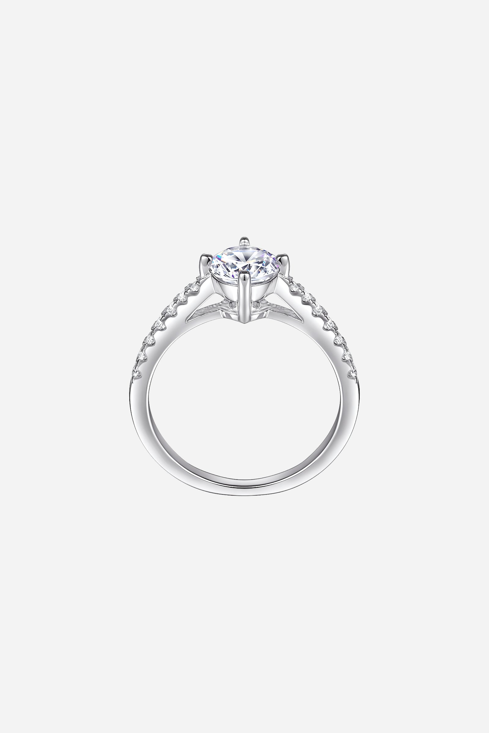 Side-angle image of GLISTIA Round Cut Zircon Solitaire Ring showcasing the raised prong setting and polished silver band.