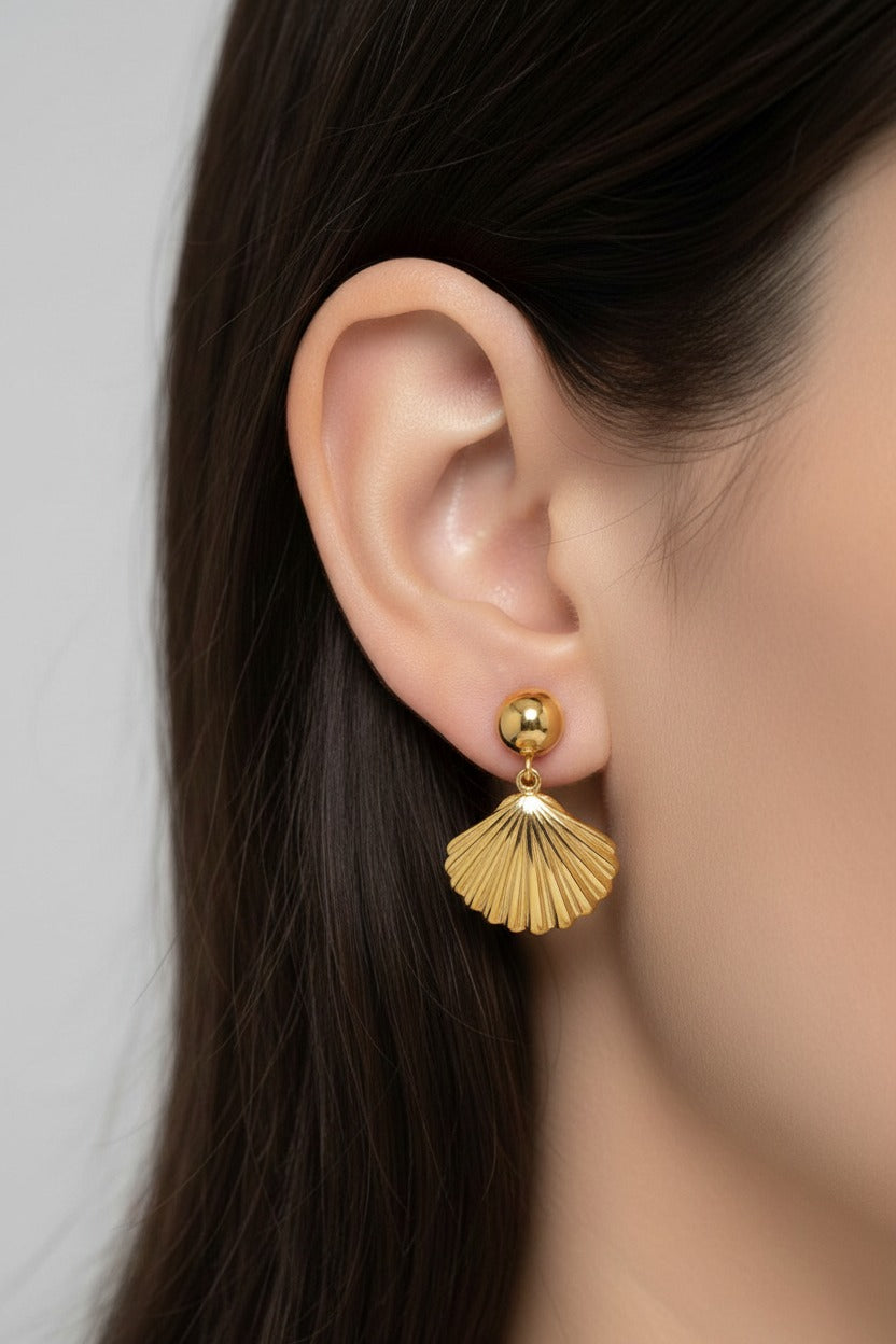Seashell drop earrings crafted from stainless steel with 18K PVD gold plating, featuring polished shell-inspired pendants.