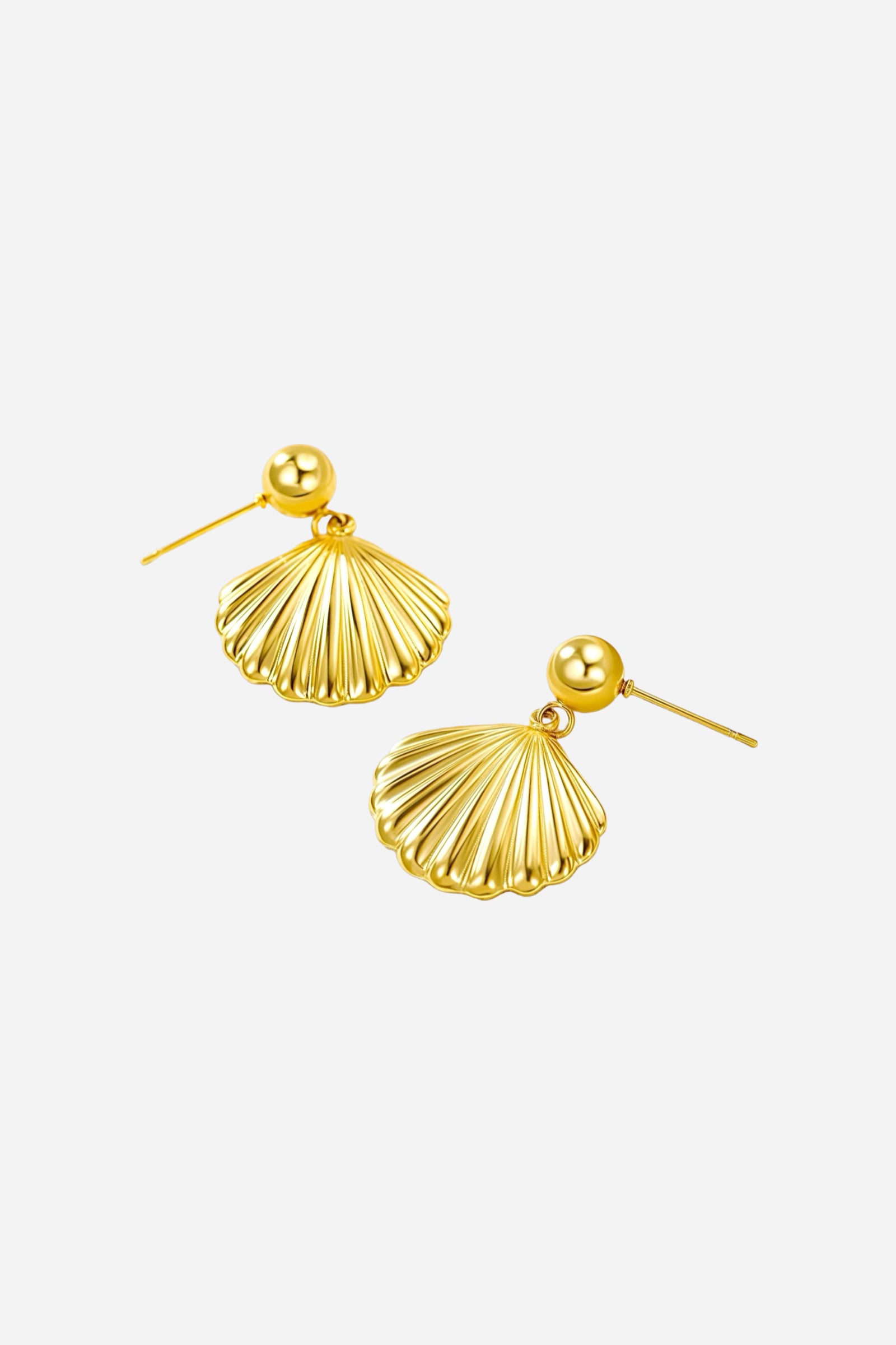 Angled view of seashell drop earrings crafted from stainless steel with a radiant PVD 18K gold plated finish, showcasing polished shell-inspired drops and smooth rounded studs - GLISTIA.