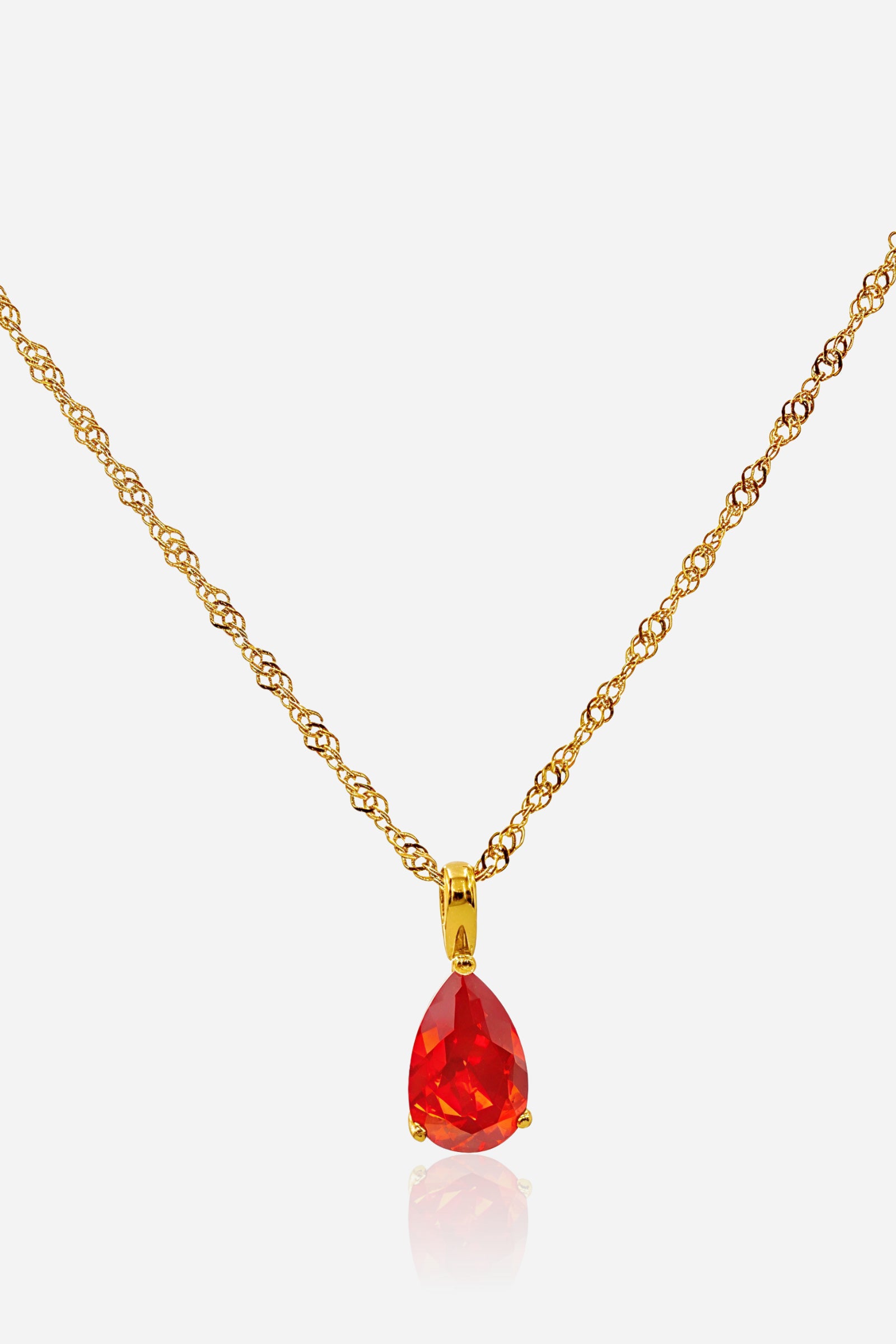 Top view of the Siam Birthstone Necklace January featuring a teardrop Siam red crystal on an 18K gold plated stainless steel chain.