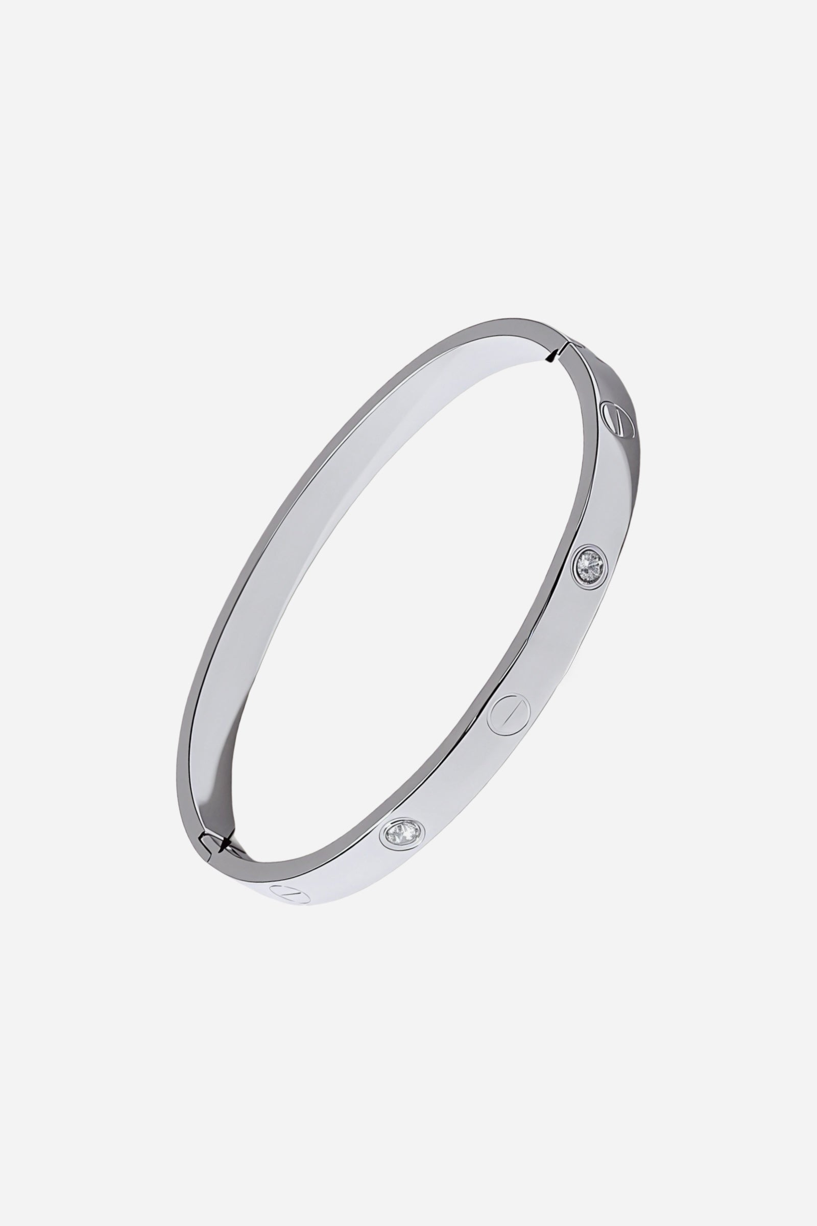 Side angle showing the sleek mirror-polished silver finish and screw-and-crystal detailing on the stainless steel bangle – GLISTIA.