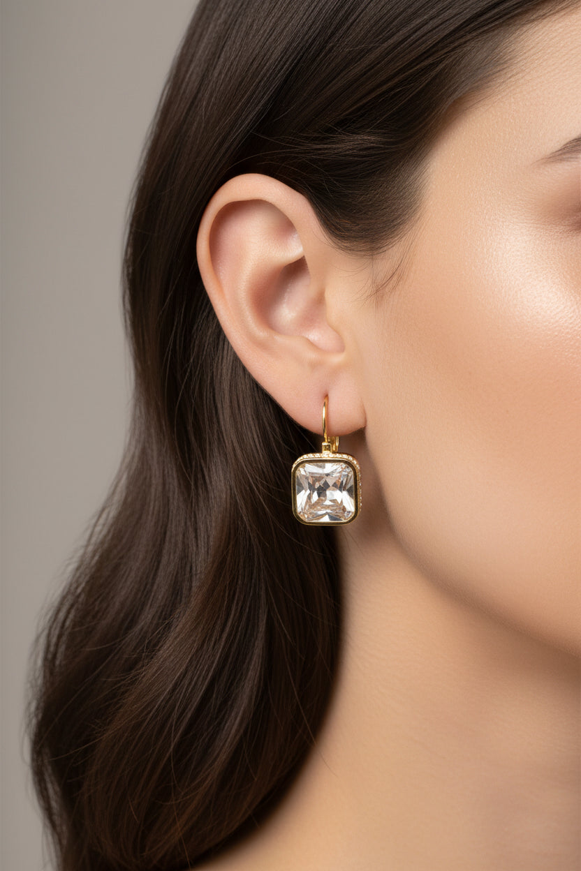 Square crystal drop earrings crafted from stainless steel with 18K PVD gold plating, featuring a faceted crystal and polished gold frame.