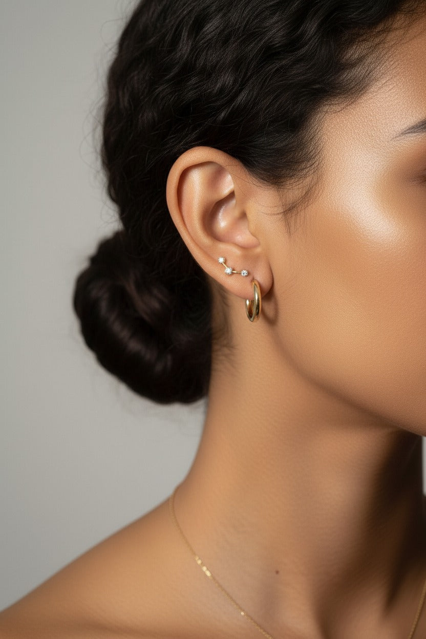 Star curve crystal stud earrings crafted from stainless steel with 18K PVD gold plating, featuring a curved bar design with star motif and cubic zirconia crystals