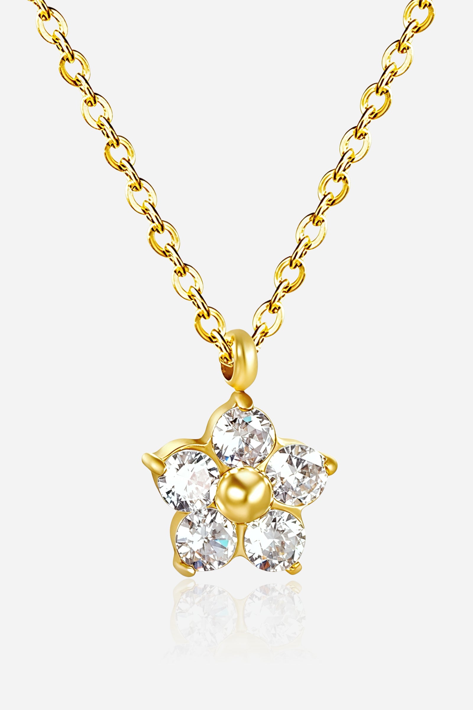 Close-up of GLISTIA Stella Star Necklace showcasing brilliant-cut crystals arranged in a star with gold detailing.