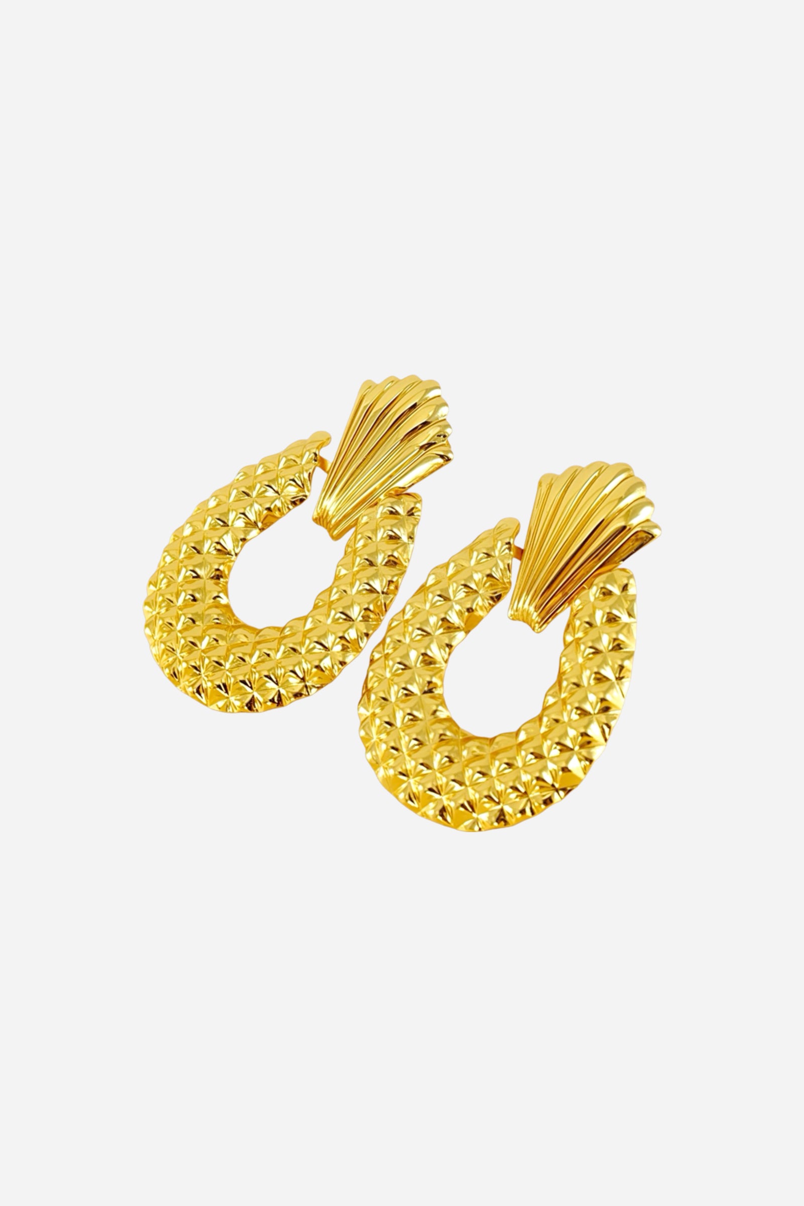 Side view of textured drop statement earrings made from stainless steel with a PVD 18K gold plated finish, featuring a sculpted fan top and diamond-patterned oval drop – GLISTIA
