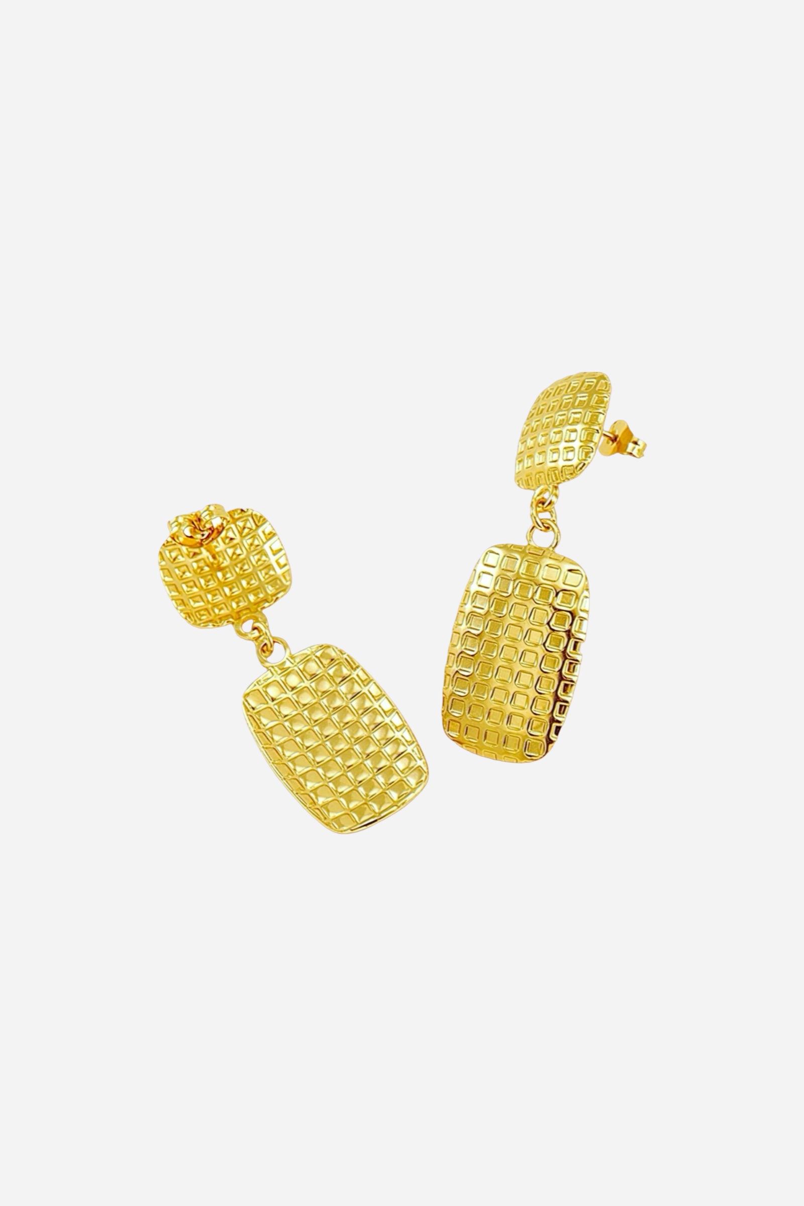 Side angle view of textured geometric drop earrings crafted from stainless steel with PVD 18K gold plating, showcasing grid-patterned rectangular drops and polished finish - GLISTIA.