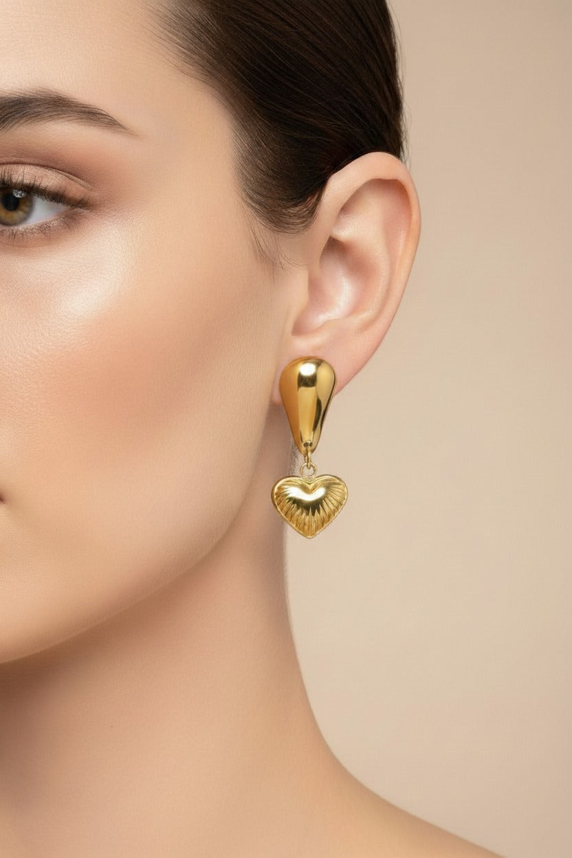 Textured heart drop earrings crafted from stainless steel with 18K PVD gold plating, featuring an elongated polished stud and detailed heart charm.
