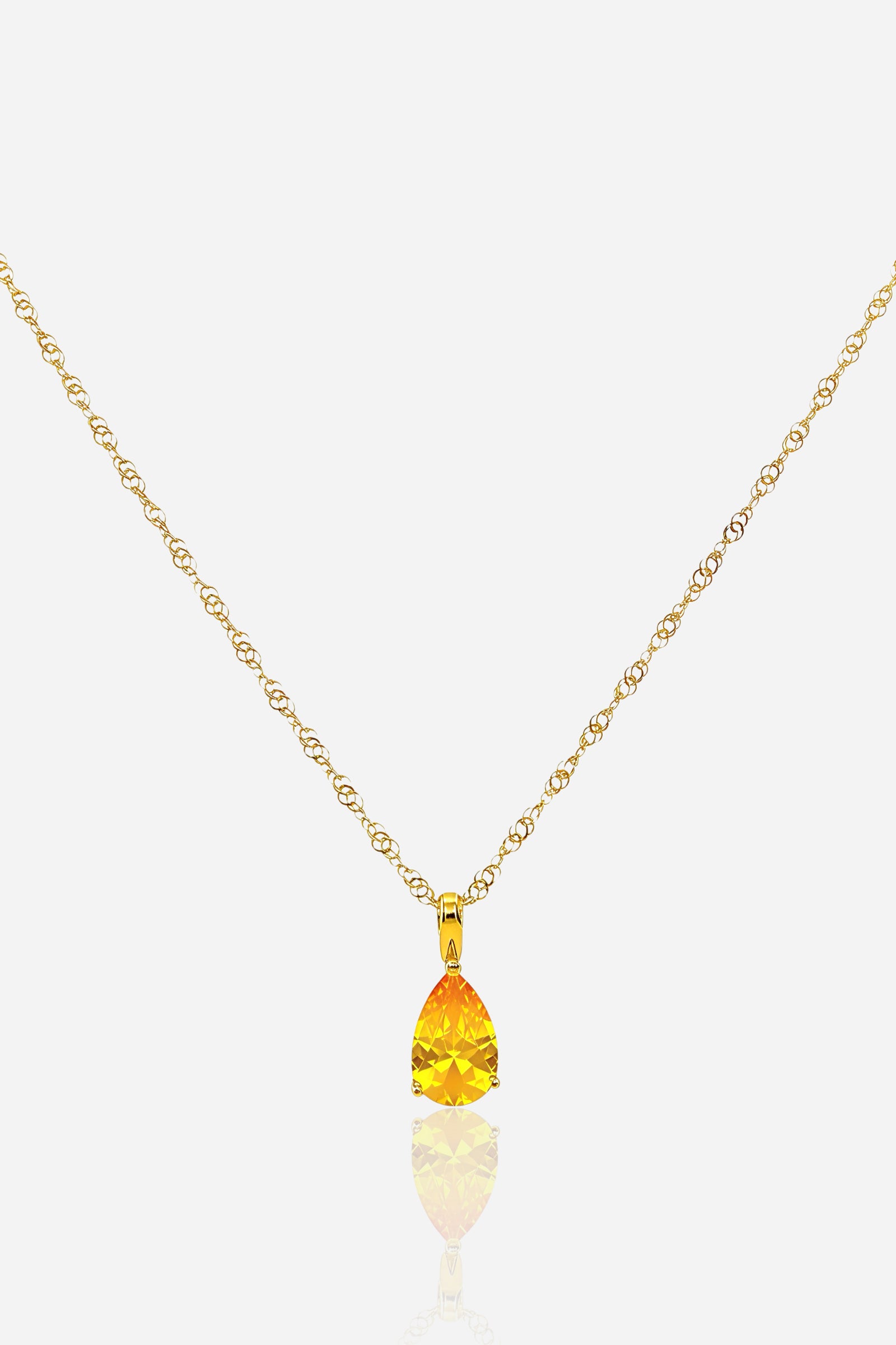 Close-up of yellow topaz-coloured zircon teardrop pendant on 18K PVD gold-plated stainless steel necklace – GLISTIA.