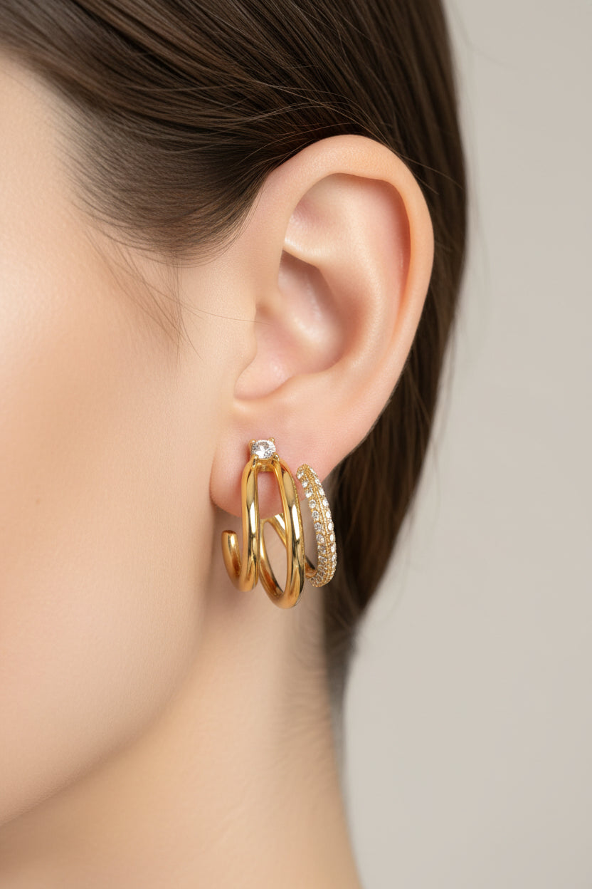 Triple row crystal hoop earrings worn on ear, crafted from stainless steel with 18K PVD gold plating and pavé crystal detailing
