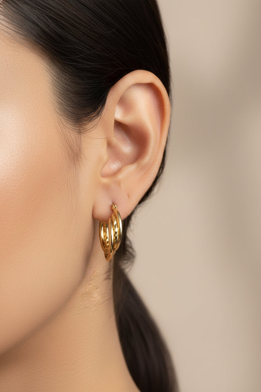 18K PVD gold plated twist detail double hoop earrings on model, minimalist polished gold hoops by GLISTIA