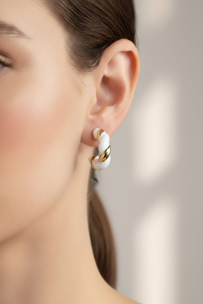 White and gold twist C-hoop earrings crafted from stainless steel with 18K PVD gold plating, featuring a modern twisted design and polished finish
