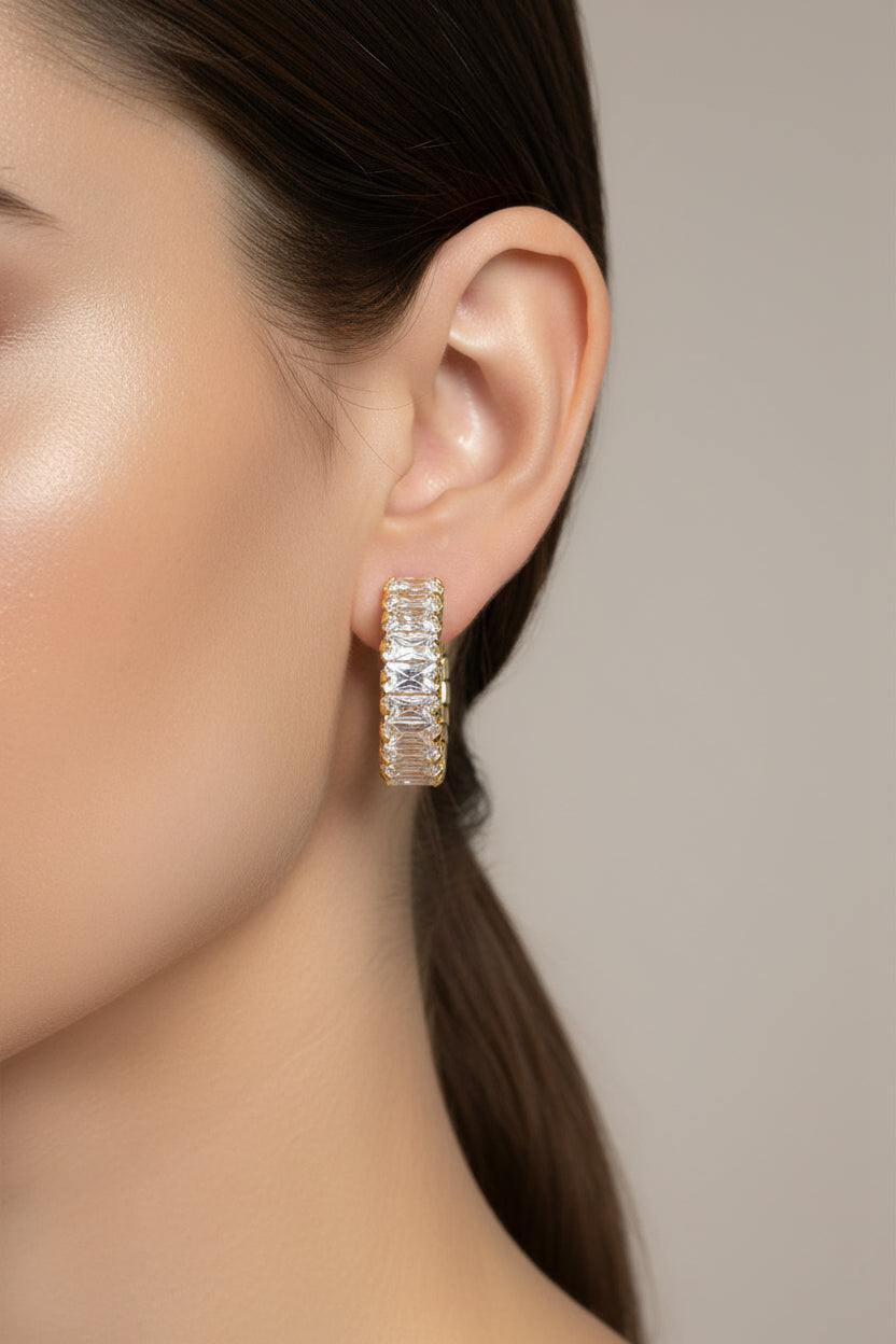 Close-up of zirconia C-hoop earrings in 18K PVD gold plated stainless steel, showcasing a refined C-shaped design with brilliant zirconia detailing