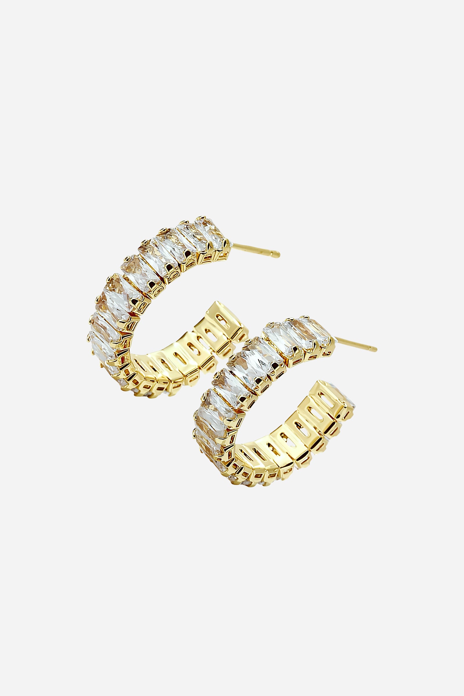 Side angle showing the zirconia-encrusted C-hoop earrings in gold finish – GLISTIA